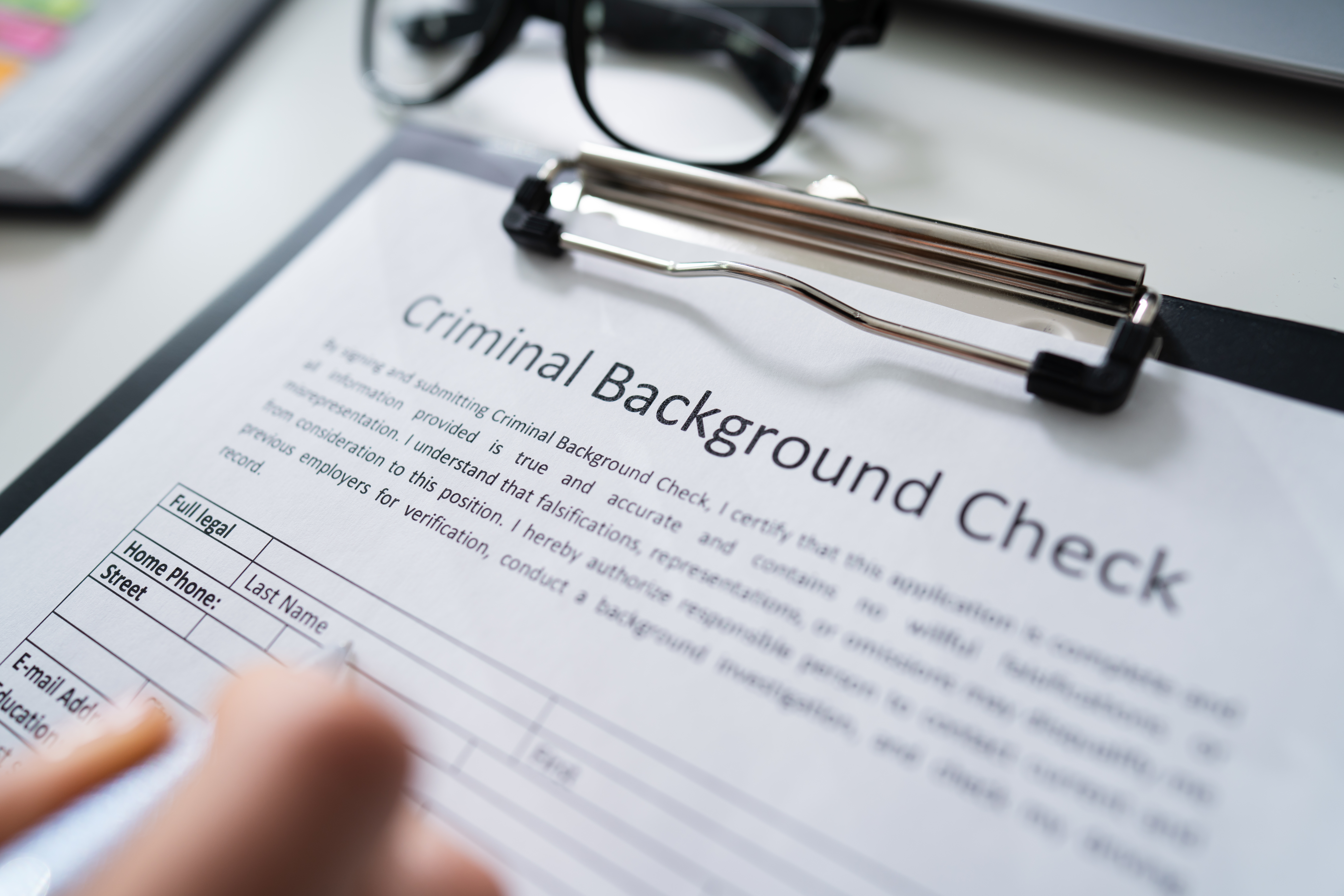 An image of the criminal background check paperwork on a clipboard